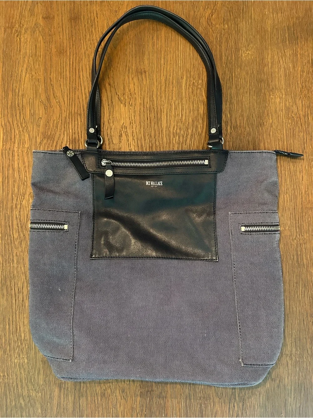 MZ Wallace navy canvas tote with leather pocket and handles